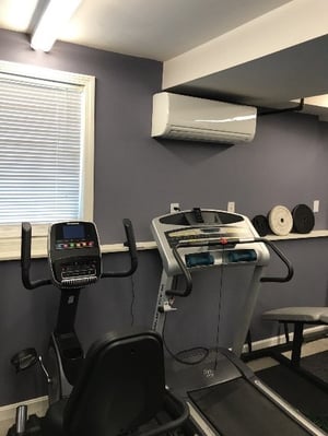 Ductless wall unit installed in a home gym in Hudson, NH.