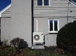 Outdoor condenser installed in Woburn, MA home for Mitsubishi ductless.