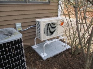 Outdoor installation of Mitsubishi ductless heat pump in Winchester.