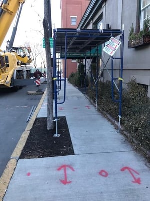 Staging for pedestrians during N.E.T.R. Inc. replacement of old heating unit. 